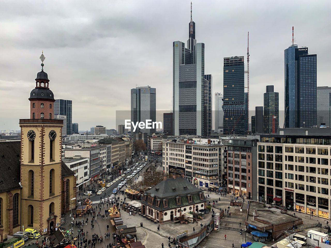 Modern buildings in city against cloudy sky