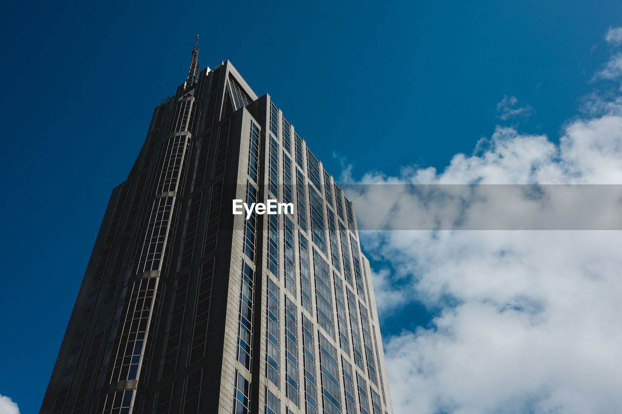 LOW ANGLE VIEW OF MODERN BUILDINGS AGAINST BLUE SKY