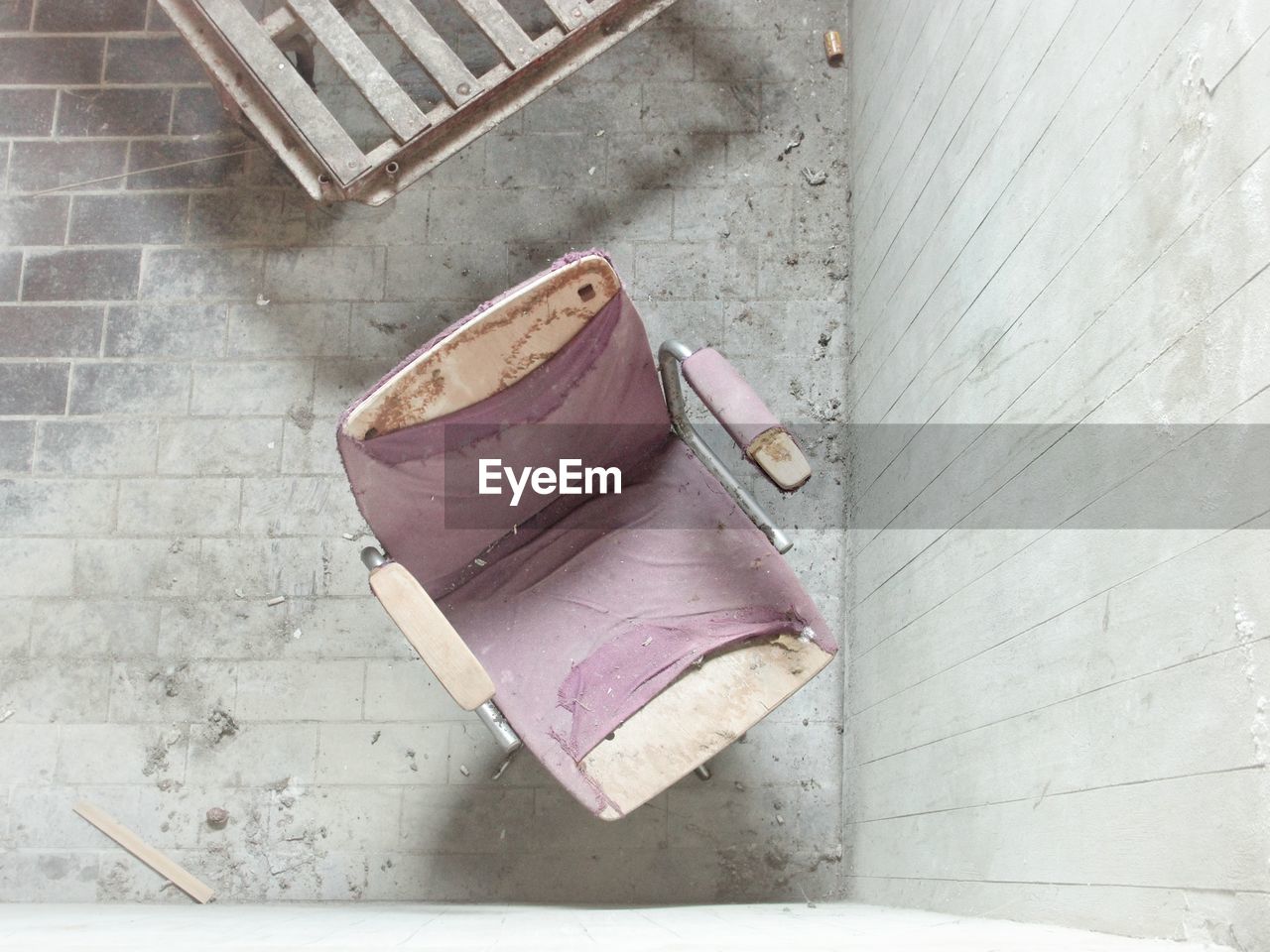 High angle view of empty chair in abandoned building