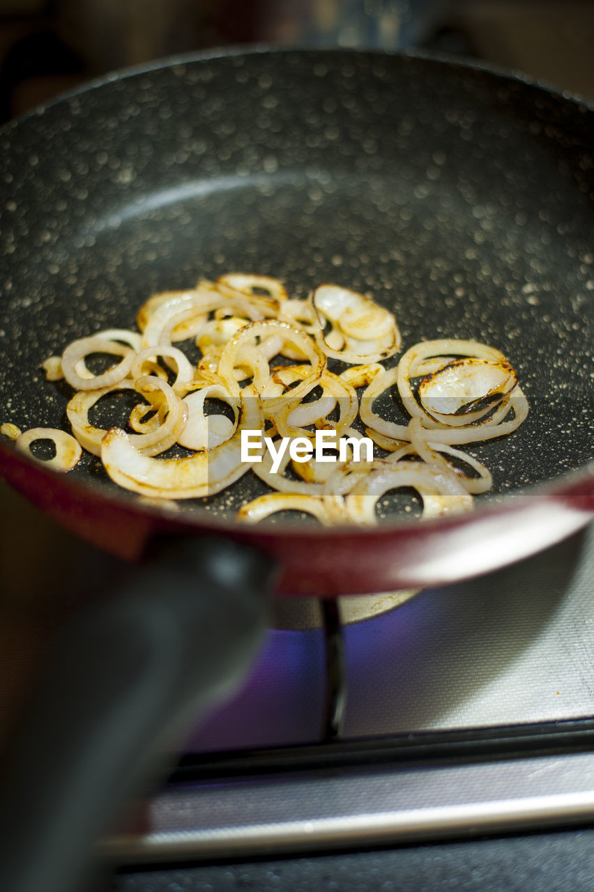 HIGH ANGLE VIEW OF PERSON PREPARING FOOD ON KITCHEN