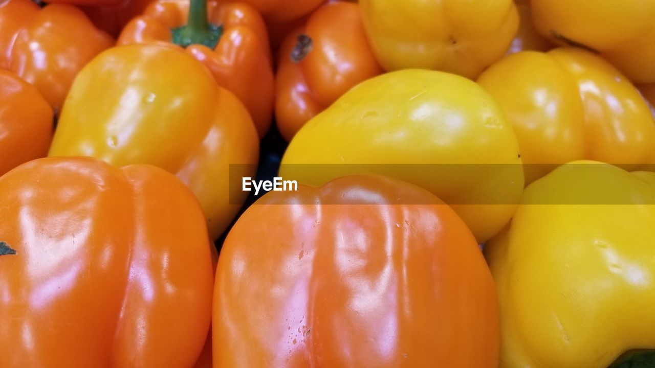 Full frame shot of yellow bell peppers for sale in market