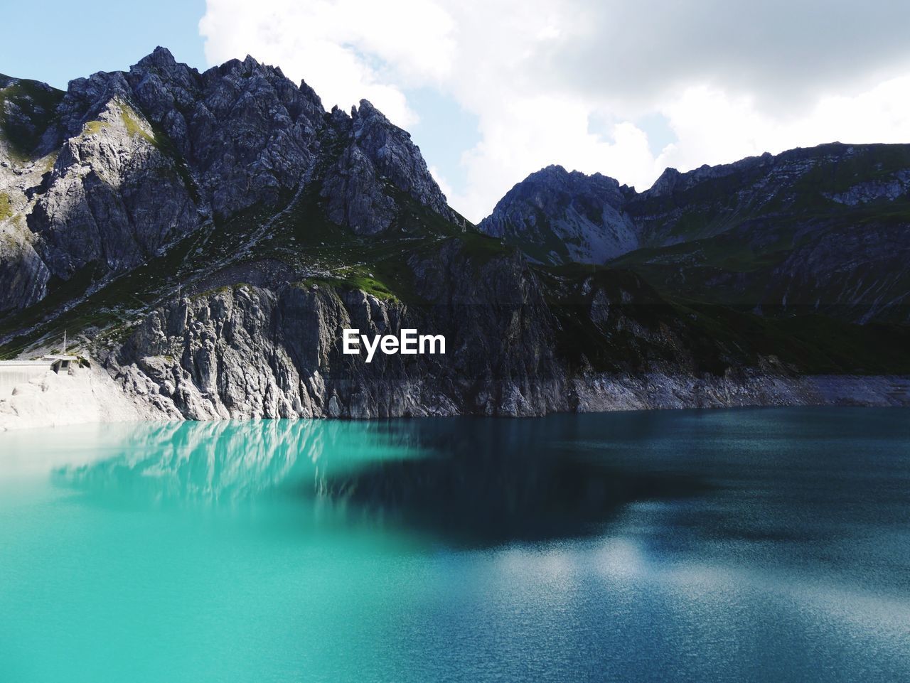 Scenic view of lake and mountains against sky