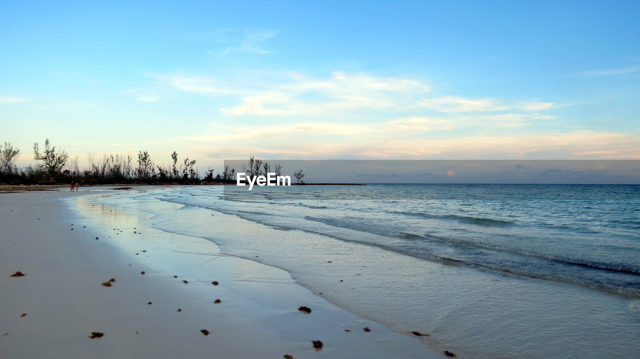 Scenic view of beach against sky during sunset