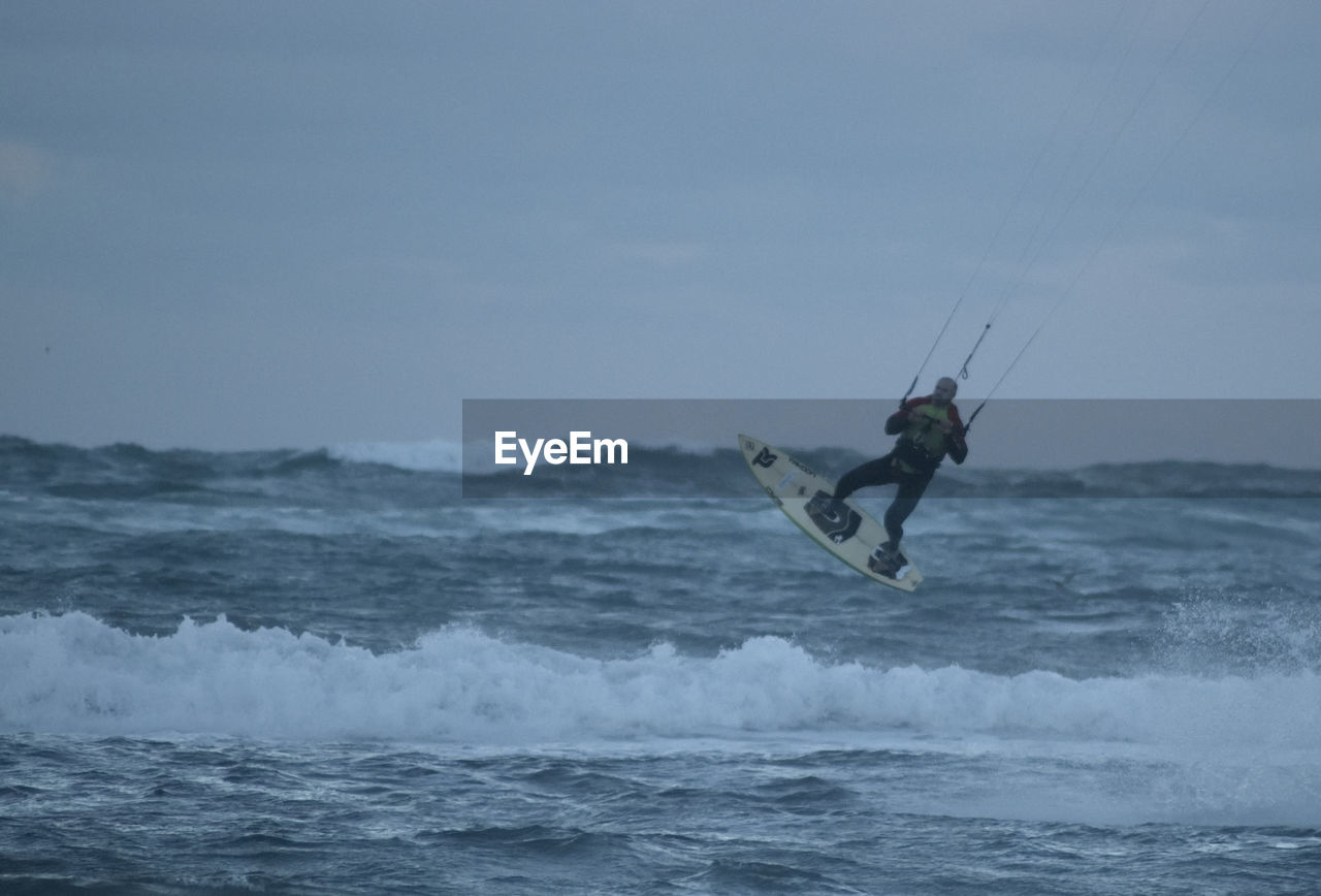 MAN SURFING IN SEA