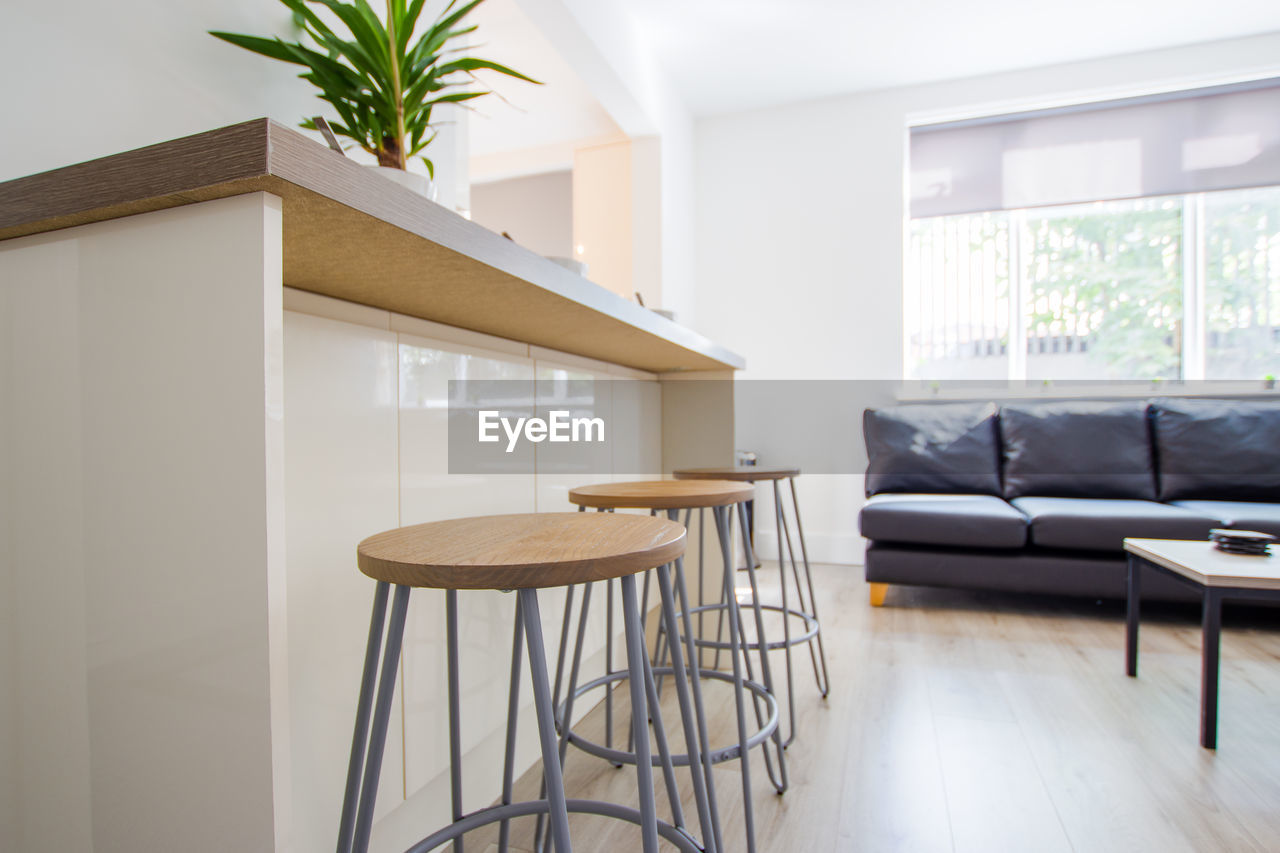 Empty chairs at breakfast bar at home