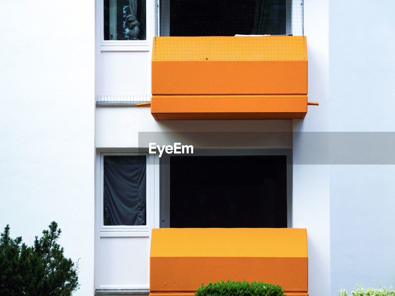 Close-up of building with orange balconies