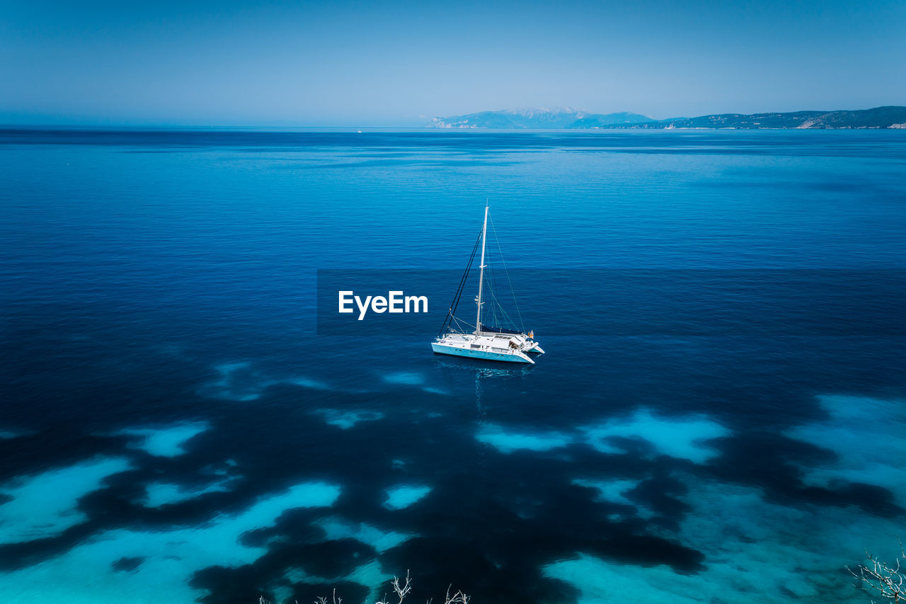 High angle view of sailboat sailing in sea against sky