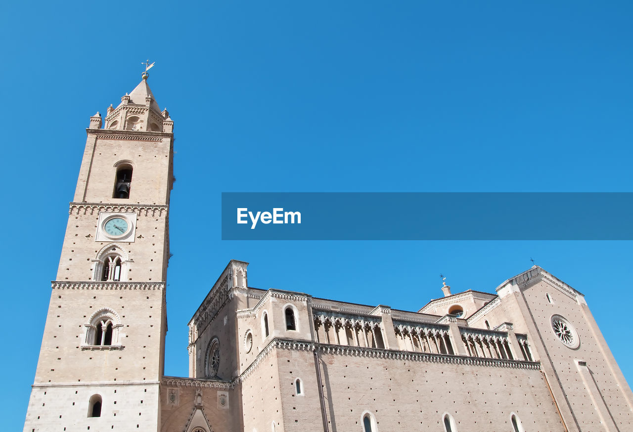 Low angle view of clock tower and chieti church building against clear blue sky