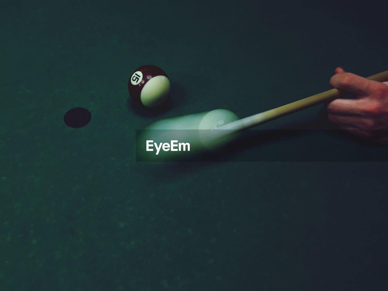 High angle view of hand playing pool