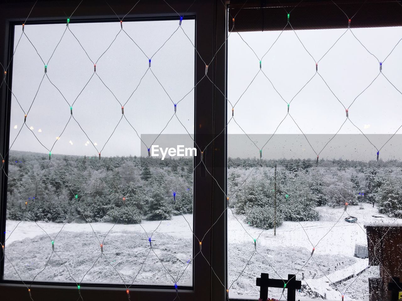 CLOSE-UP OF SKY SEEN THROUGH FENCE