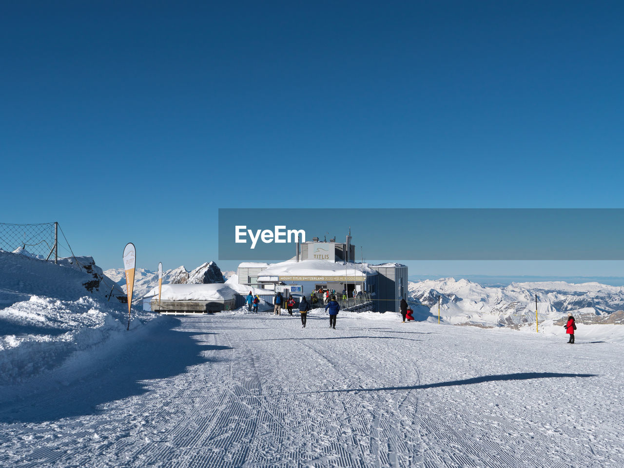 PEOPLE ON SNOWCAPPED MOUNTAIN AGAINST CLEAR SKY
