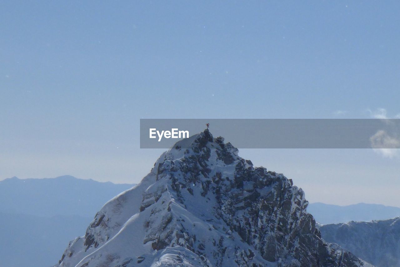 Low angle view of snowcapped mountains against sky