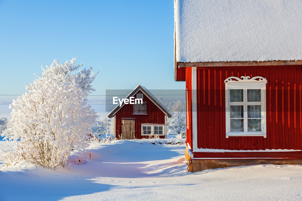 Red cottage in an idyllic winter landscape