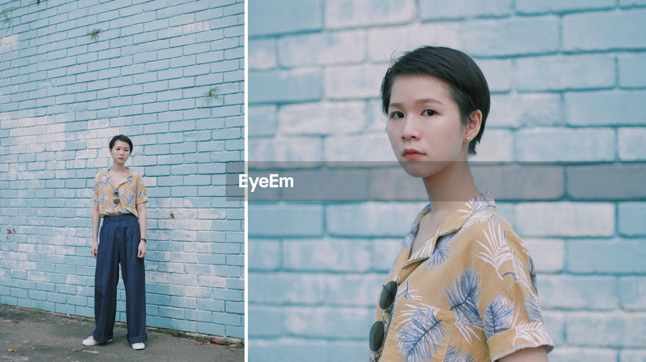 PORTRAIT OF A YOUNG COUPLE STANDING AGAINST WALL