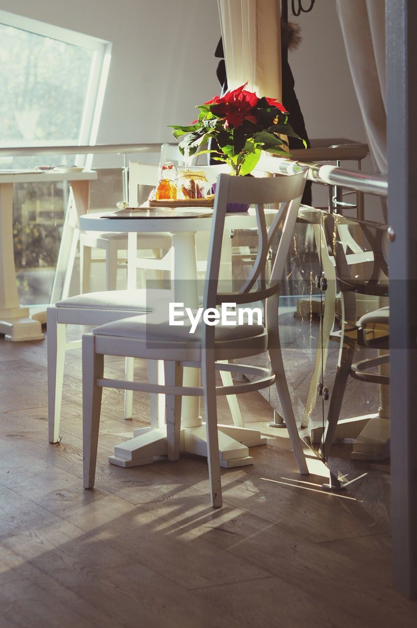 CLOSE-UP OF DINING TABLE WITH CHAIRS AT HOME