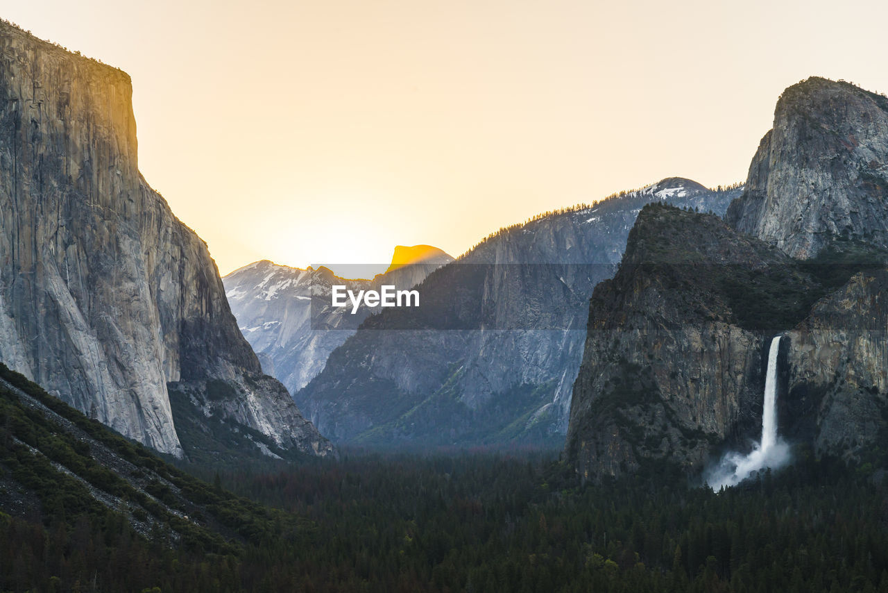 Scenic view of mountains against clear sky during sunset