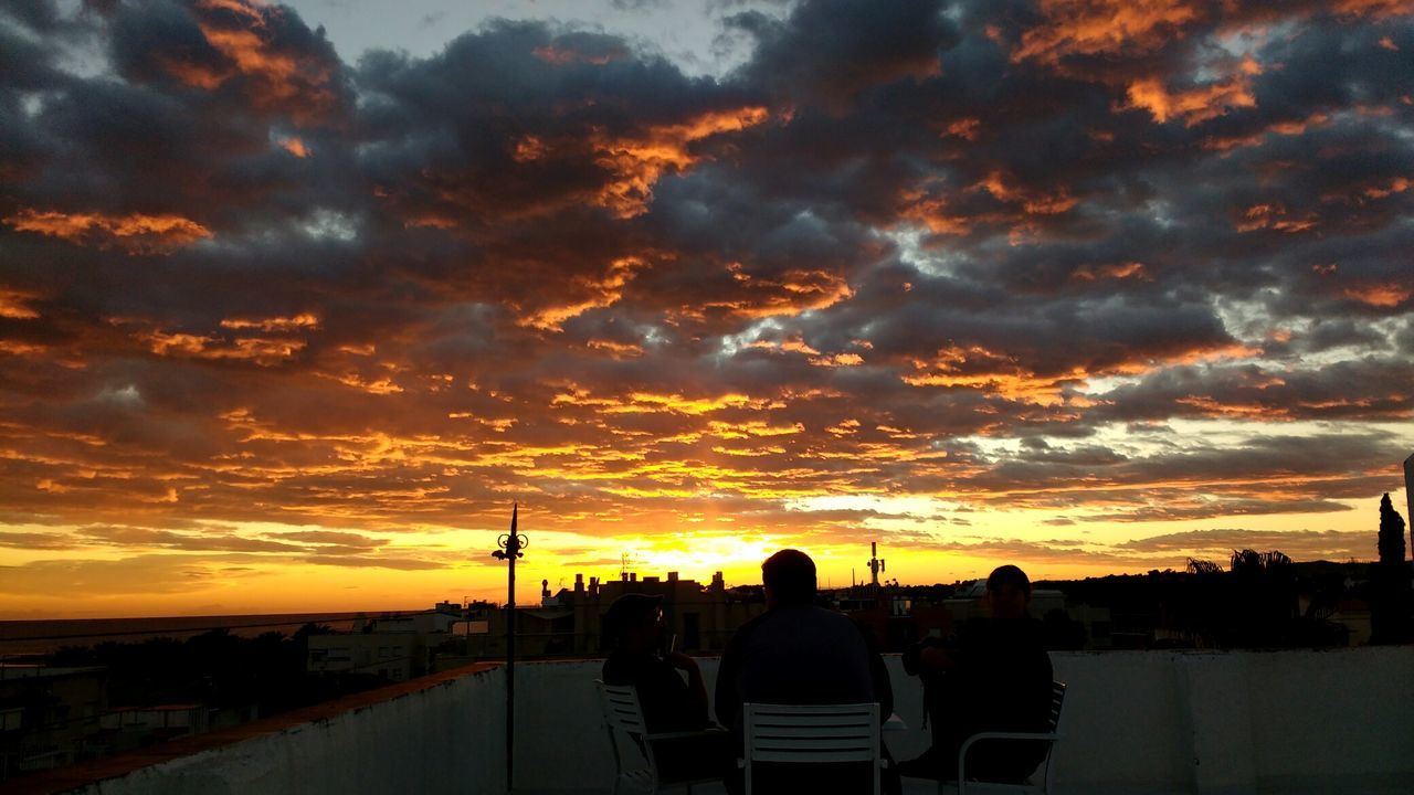 SILHOUETTE PEOPLE AGAINST ORANGE SKY AT SUNSET