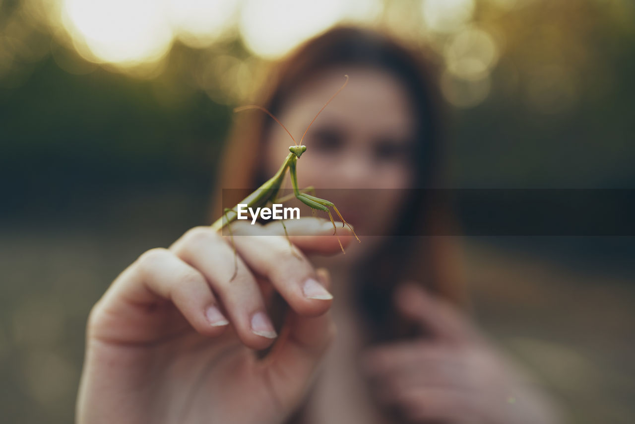 Close-up of woman with insect