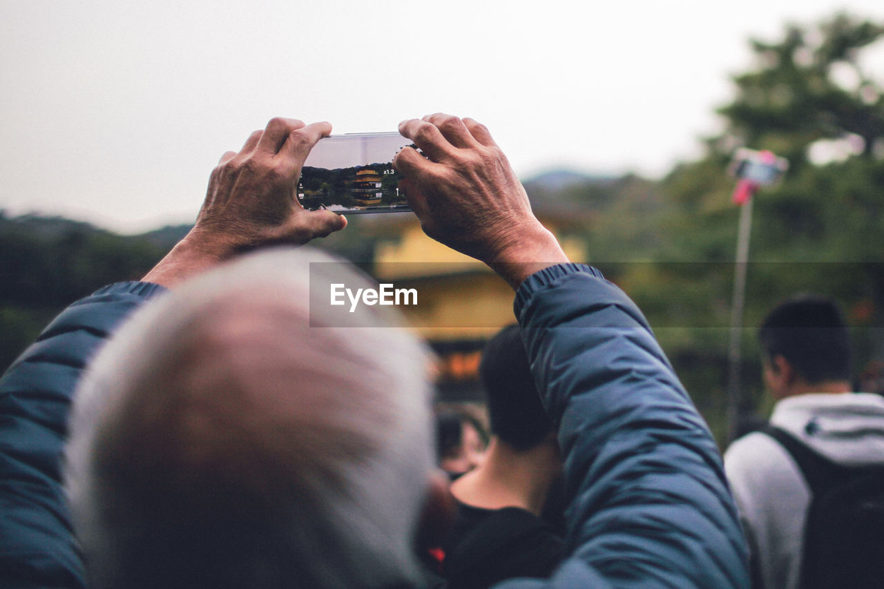 REAR VIEW OF COUPLE PHOTOGRAPHING