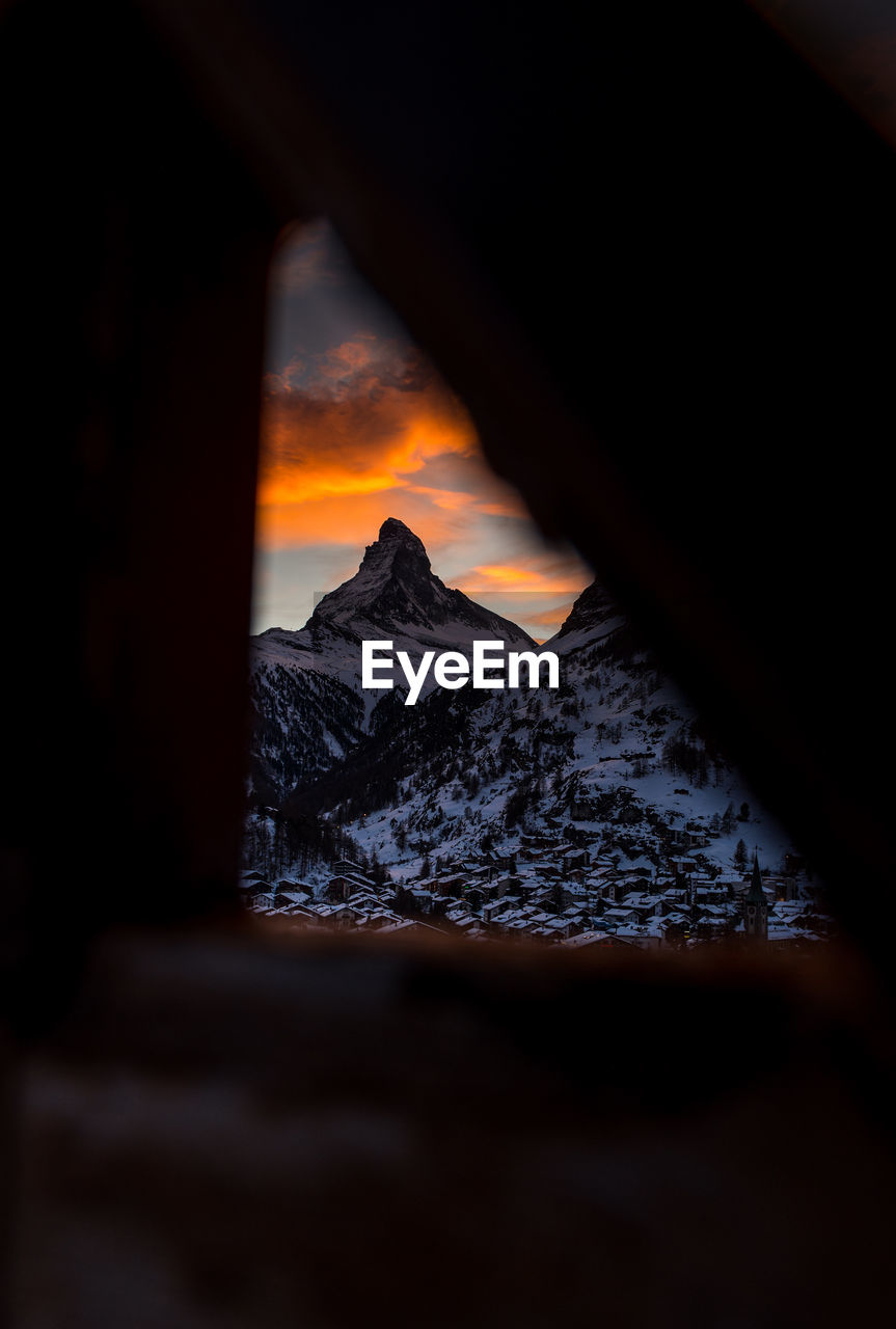 Scenic view of snowcapped mountains against sky during sunset