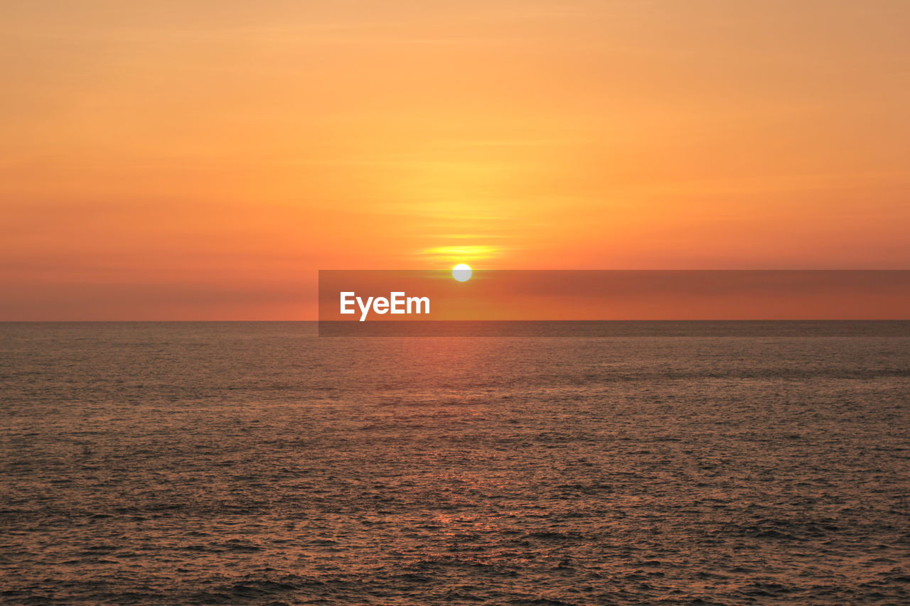 SCENIC VIEW OF SUNSET OVER SEA