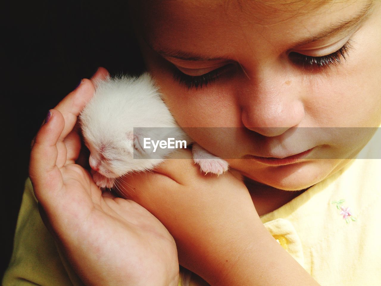 Close-up of cute girl with kitten