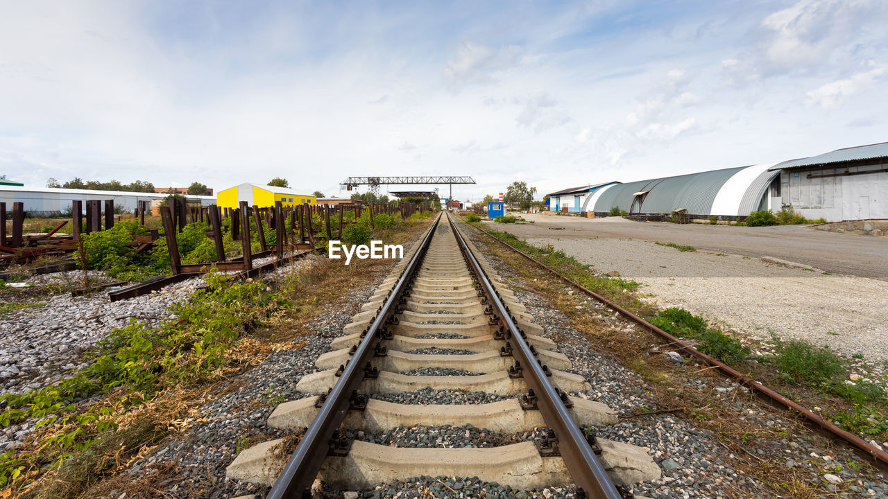 Large plan railroad tracks against the background of a construction site, production workshop