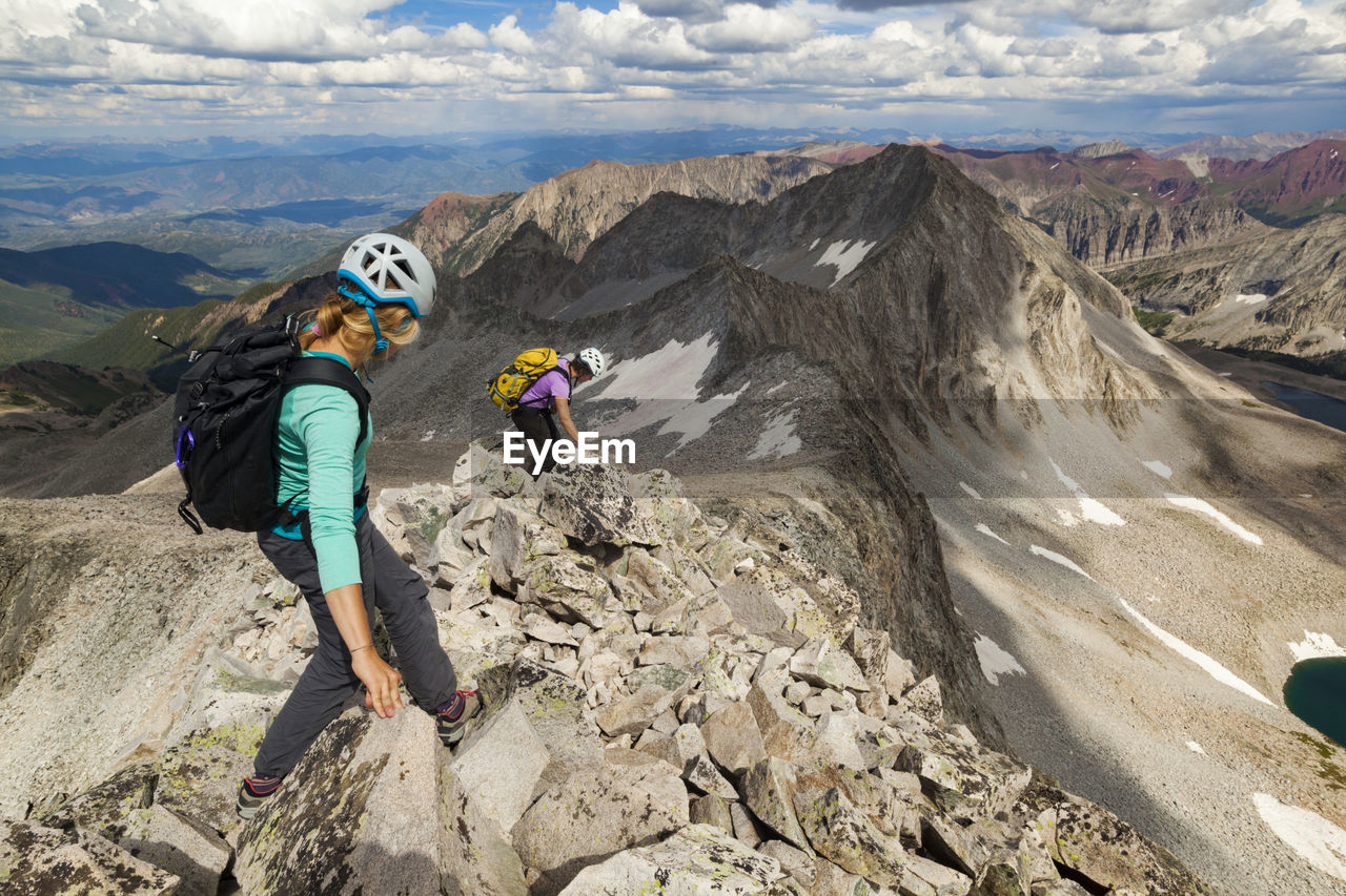 Women descend ridge on capitol peak, elk mountains, colorado