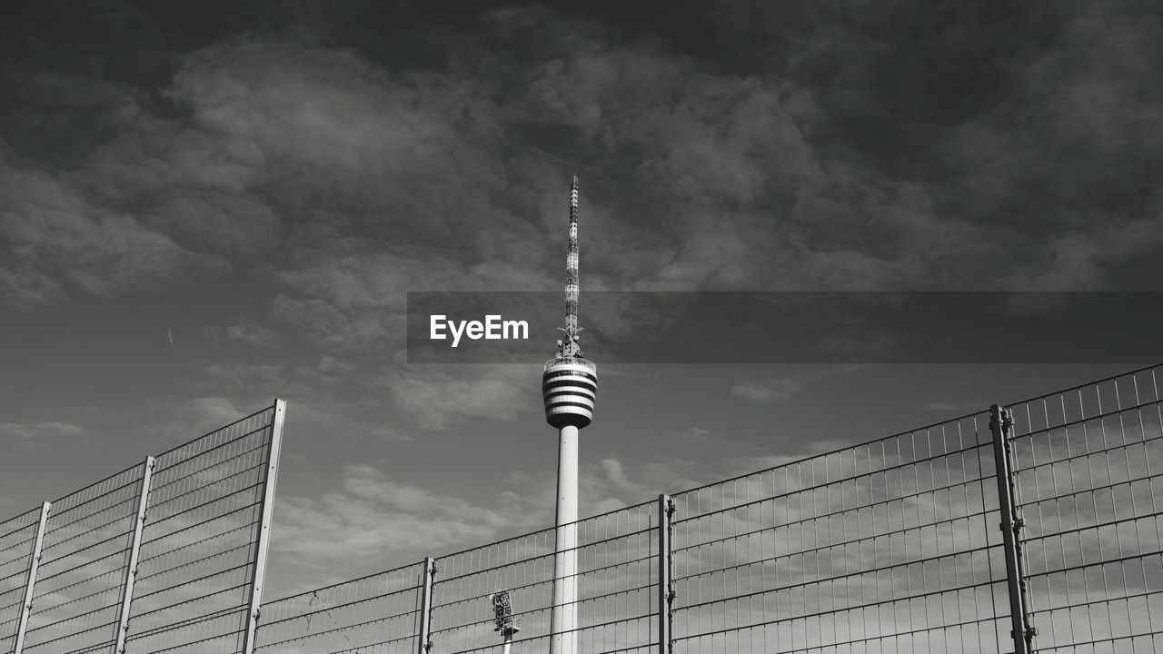 LOW ANGLE VIEW OF COMMUNICATIONS TOWER IN CITY