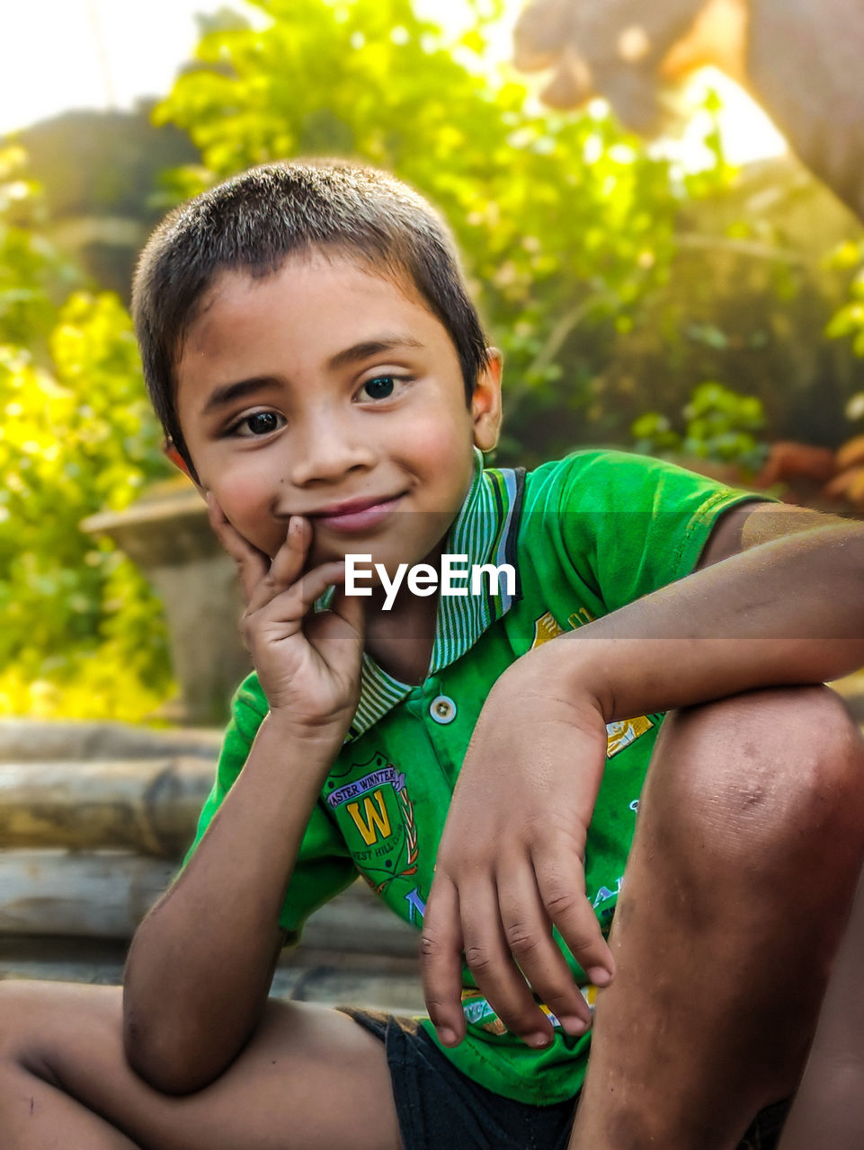 Portrait of village boy sitting outdoors