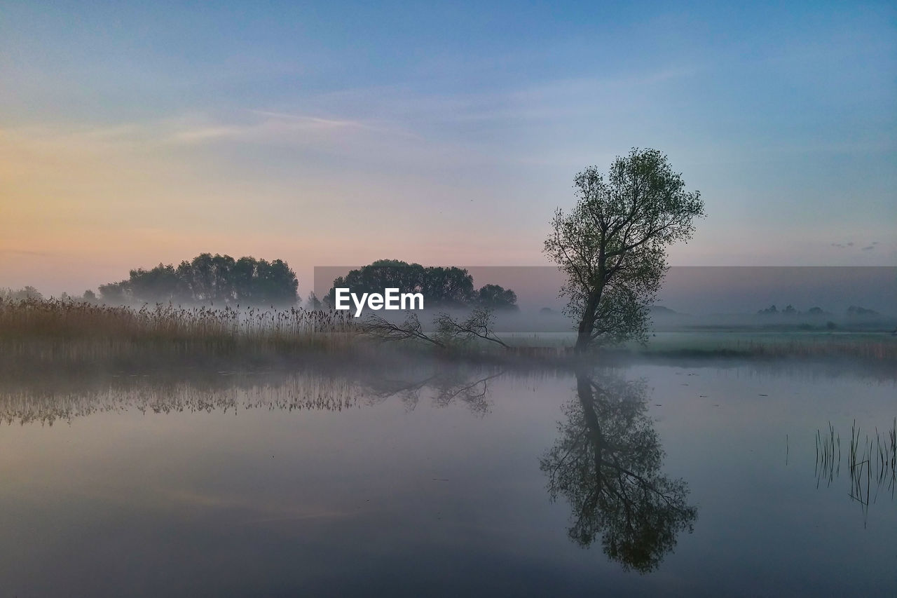 Scenic view of lake against sky during sunset