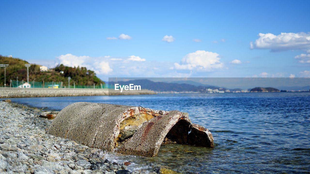 SCENIC VIEW OF SEA AND ROCKS AGAINST SKY