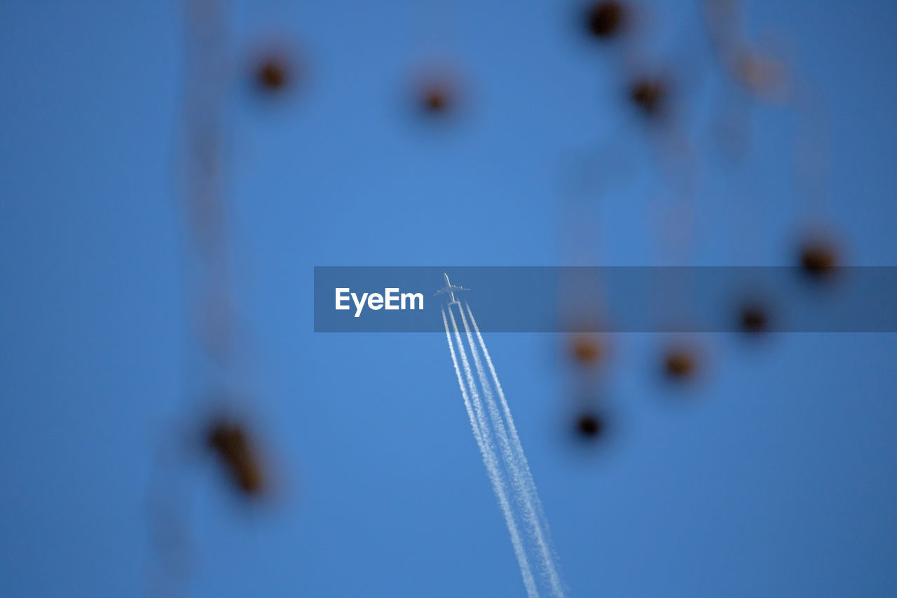 Low angle view of airplane flying against clear sky