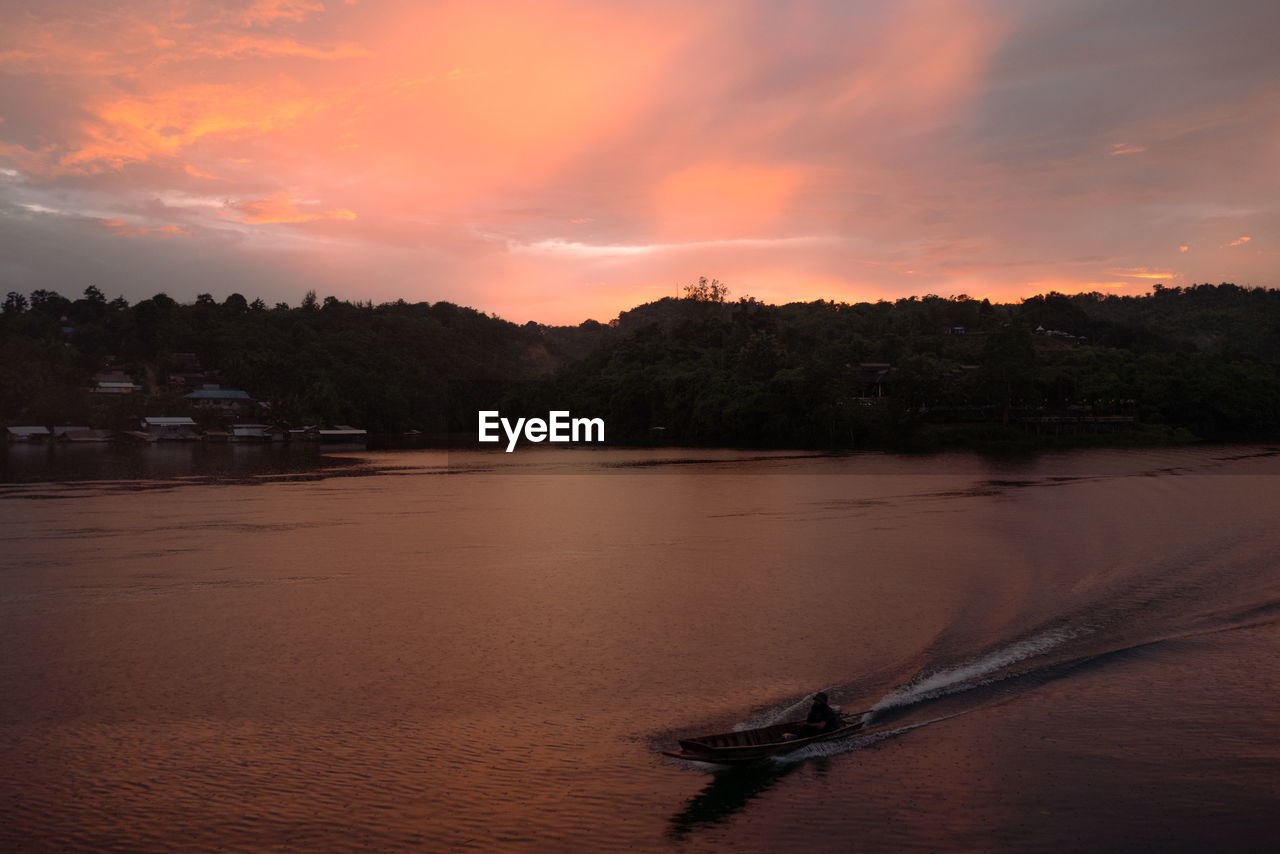 SCENIC VIEW OF RIVER AGAINST ORANGE SKY