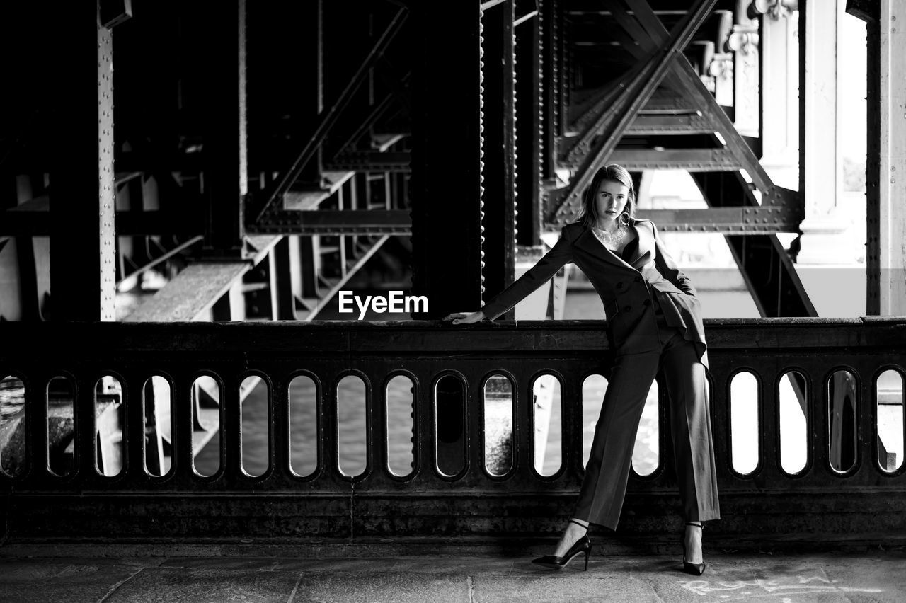 Fashion woman standing under the bridge in paris 