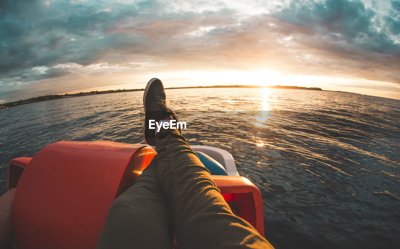 Man relaxing on a boat and enjoying the sunset