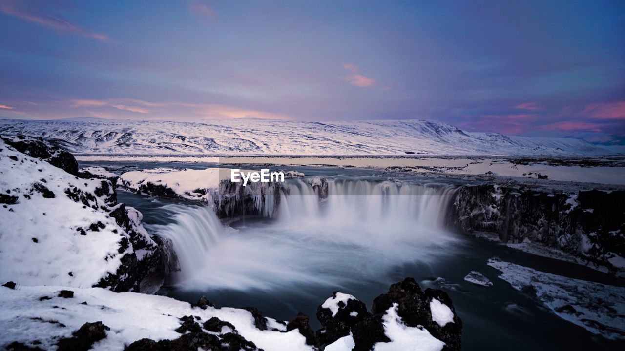 Scenic view of waterfall at night during winter