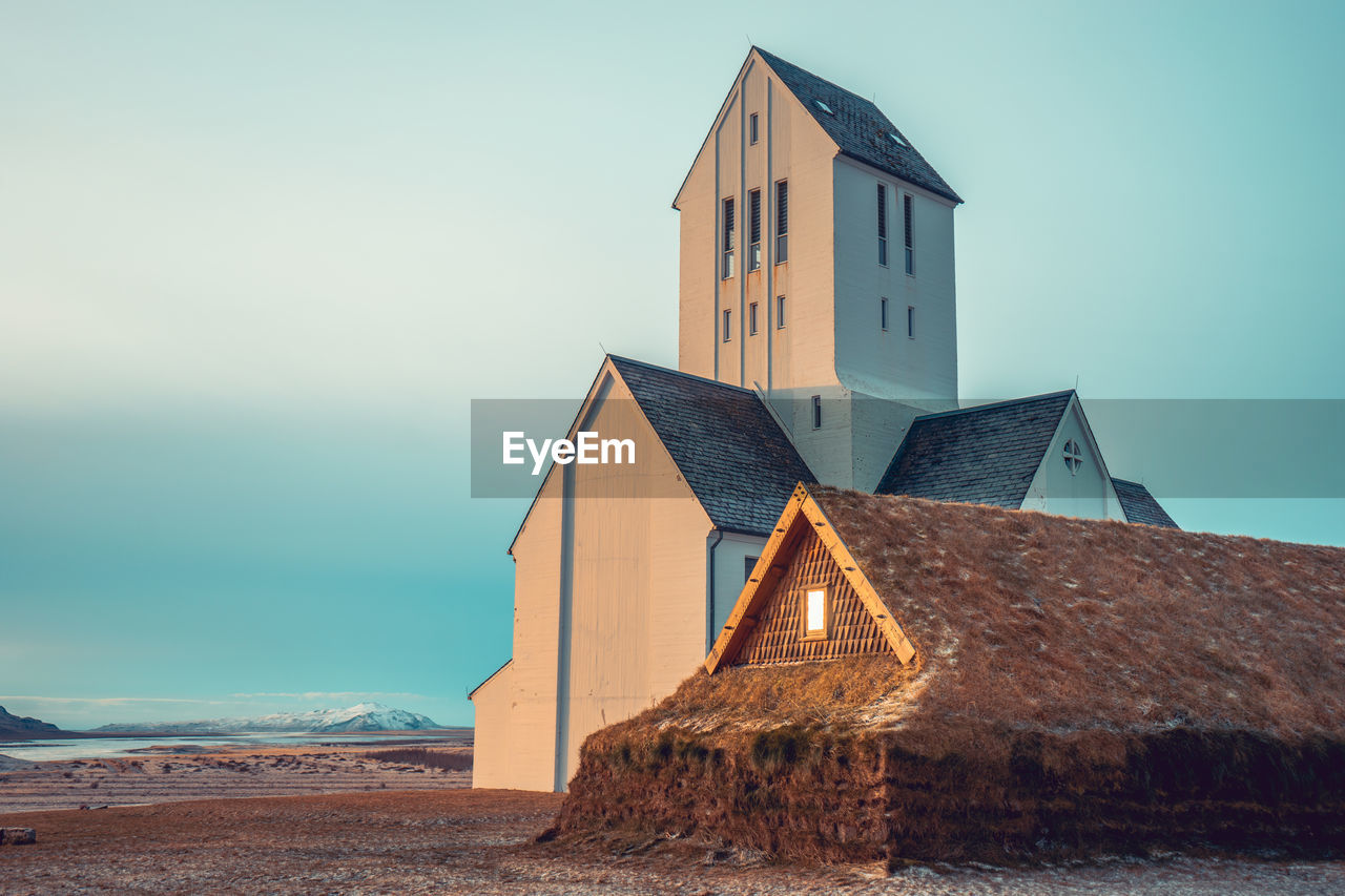 HUT BY SEA AGAINST SKY