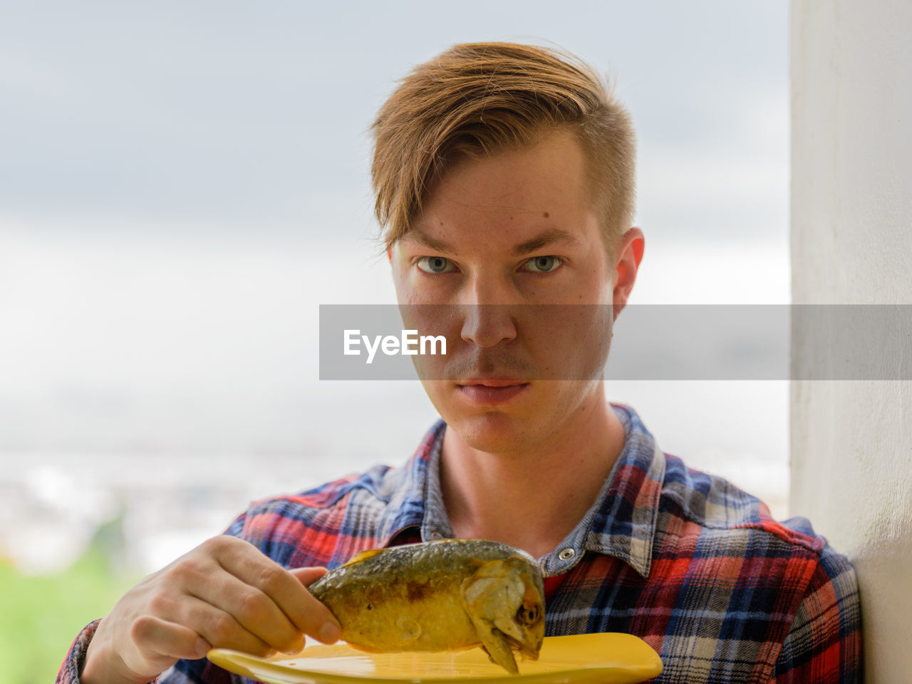 Portrait of young man holding ice cream