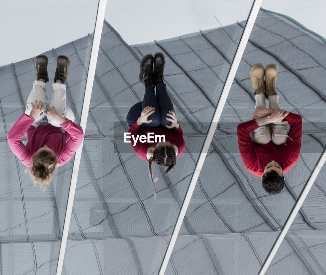 Low angle view of dancers jumping against building