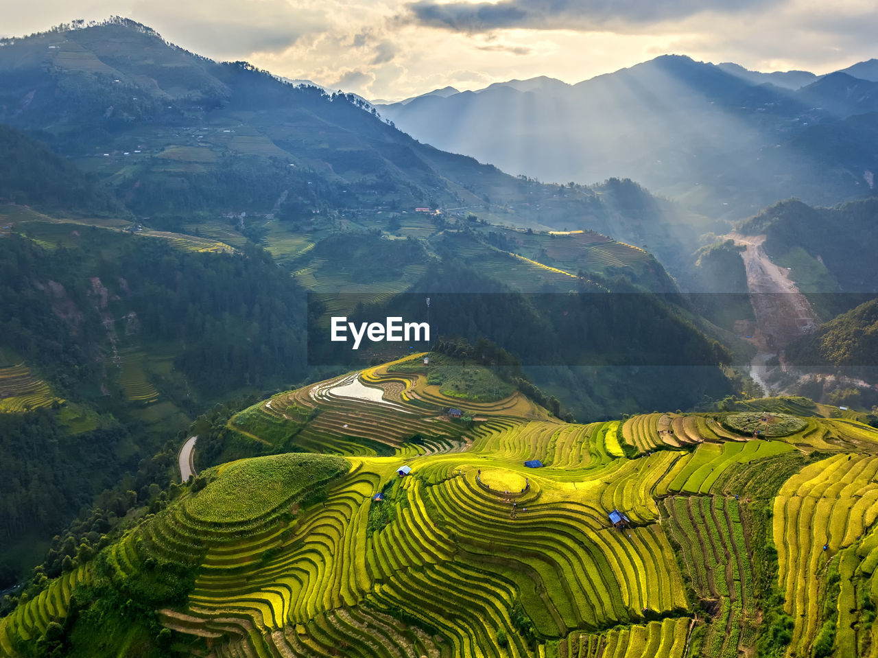 Aerial view of terraced fields and mountains against sky during sunset