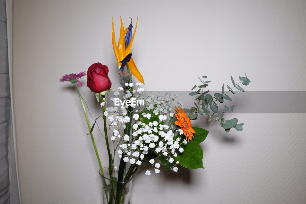 FLOWERS IN VASE ON TABLE