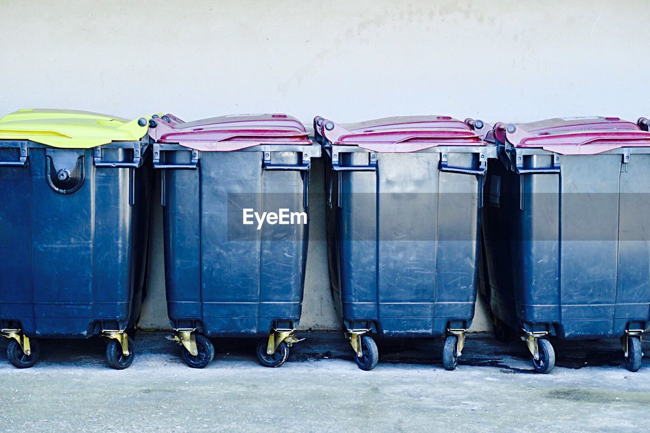 Garbage bins by wall