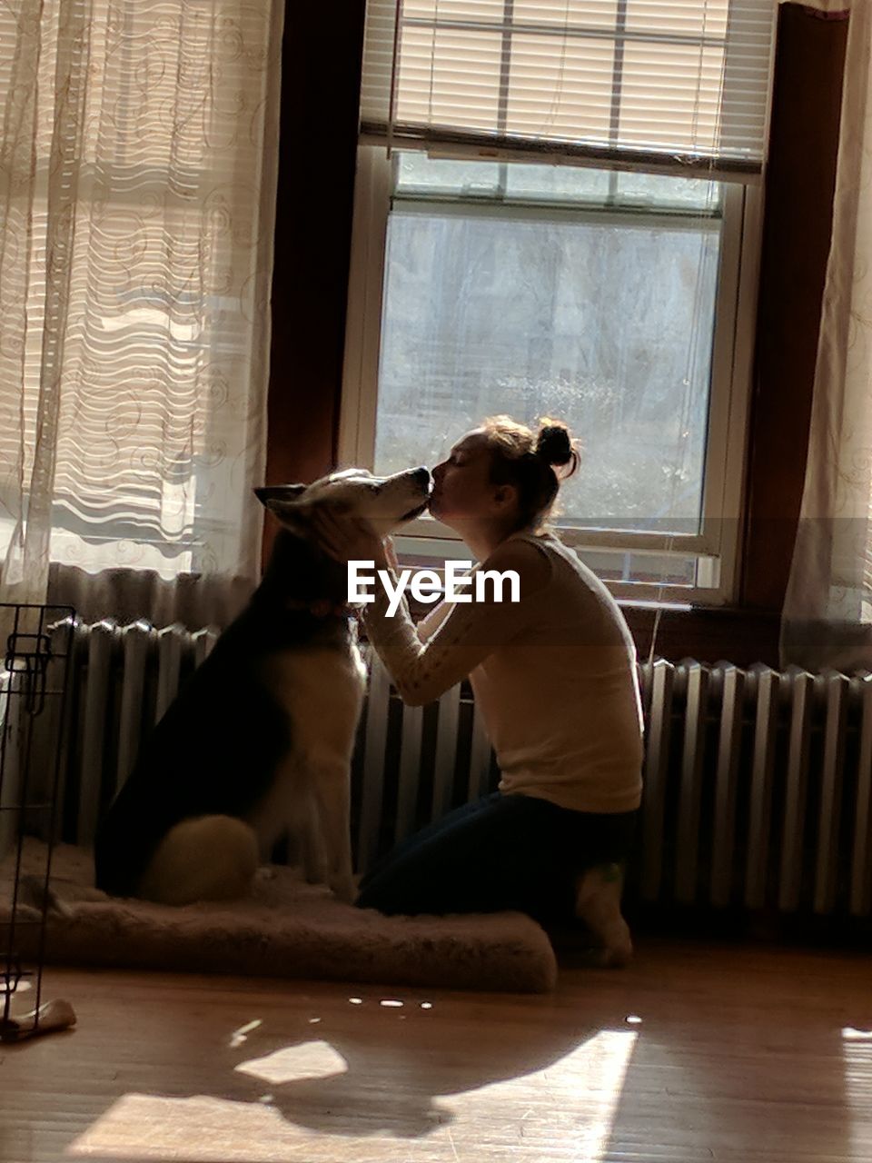 Teenage girl with dog at home