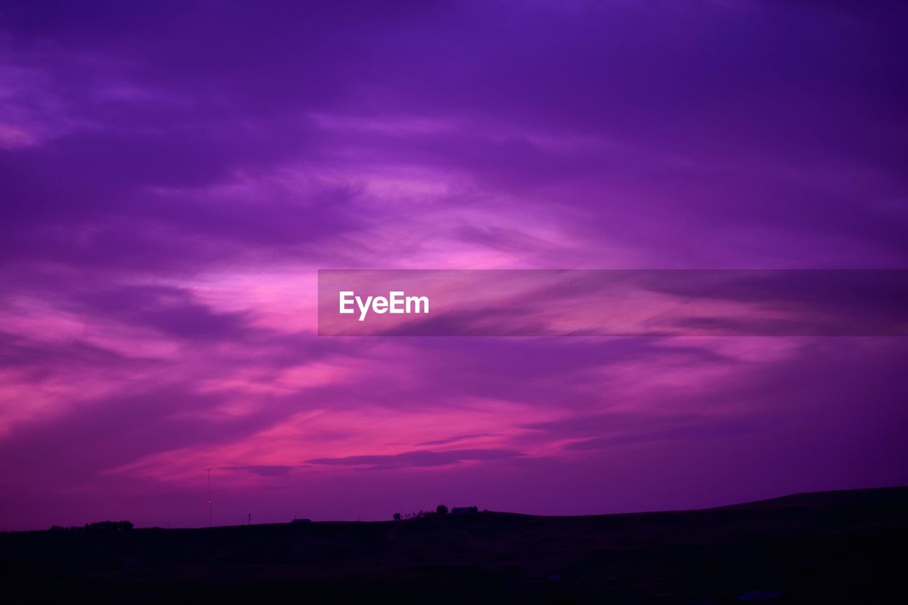 SCENIC VIEW OF DRAMATIC SKY OVER SILHOUETTE LANDSCAPE