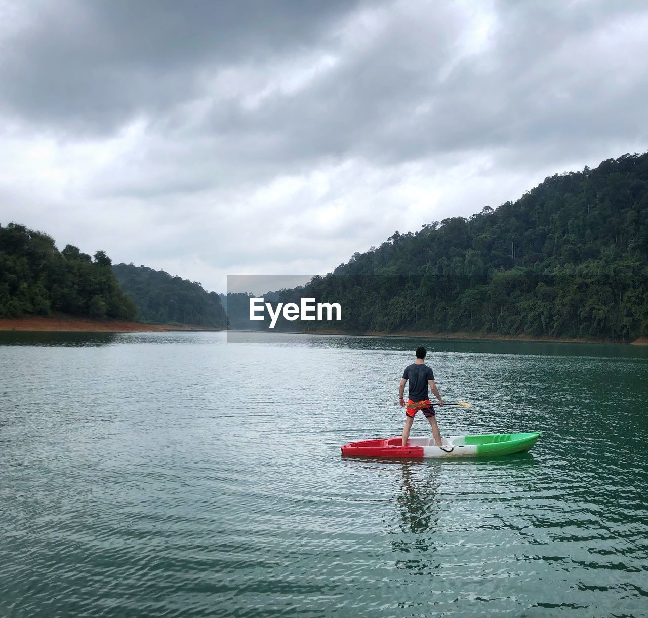 MAN ON BOAT AGAINST SKY