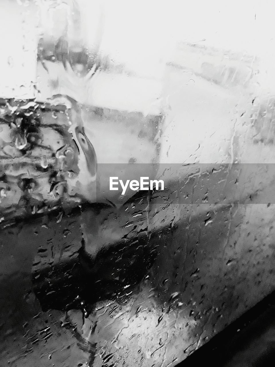 CLOSE-UP OF WET WINDOW AGAINST THE SKY