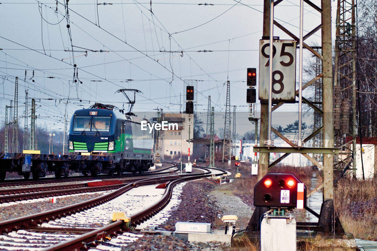 Train on railroad tracks against sky