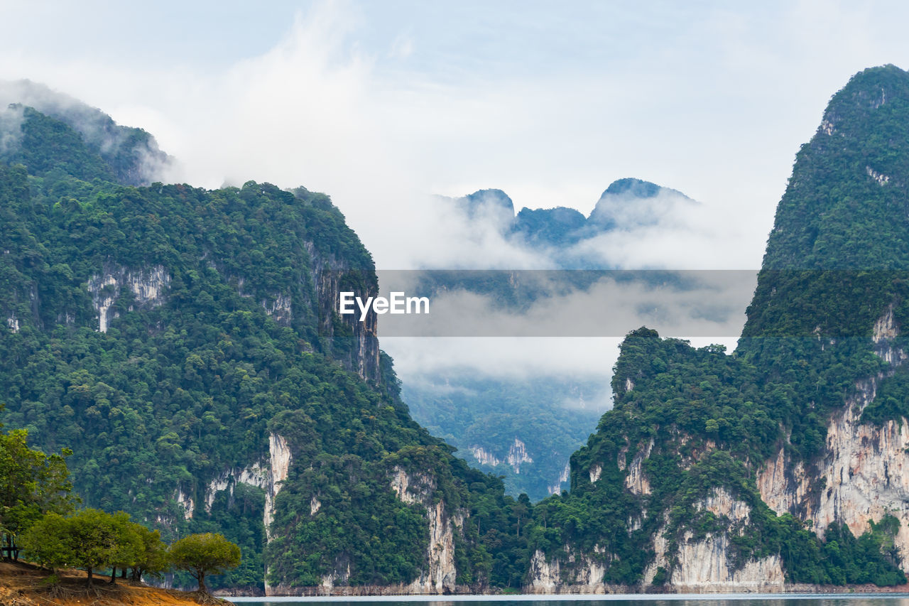 Scenic view of mountains against cloudy sky