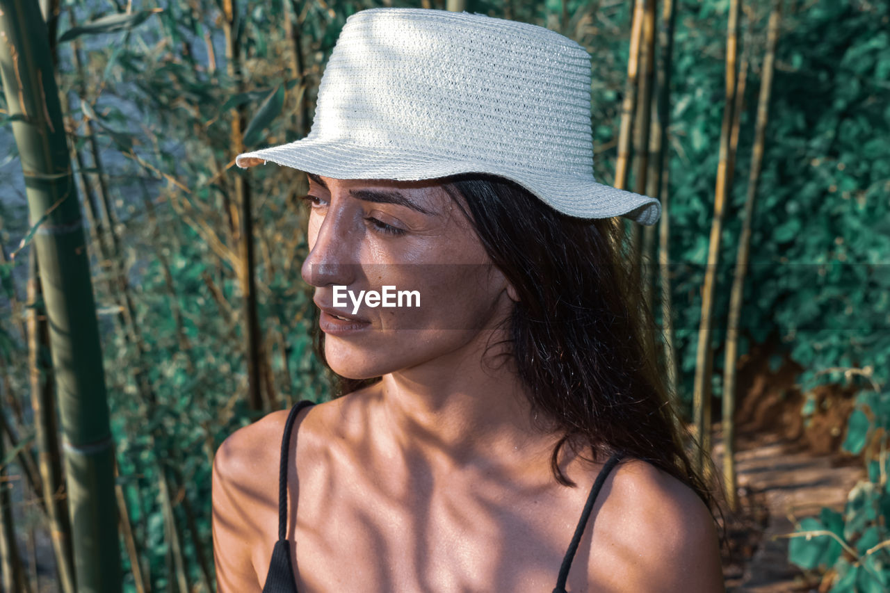 Close-up portrait of young woman wearing hat